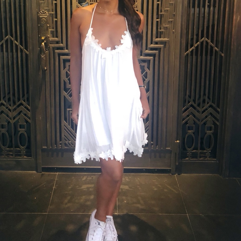 White dress with floral appliqué on top and bottom
